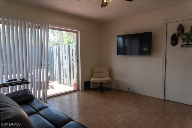 1165 Palm Ave Unit 8A, North Fort Myers, FL 33903 - living room with wood-type flooring, a ceiling fan, and a textured ceiling