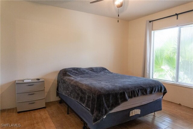 1165 Palm Ave Unit 8A, North Fort Myers, FL 33903 - bedroom with wood-type flooring, multiple windows, and ceiling fan