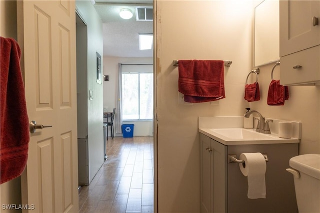1165 Palm Ave Unit 8A, North Fort Myers, FL 33903 - bathroom featuring vanity, toilet, and wood finished floors