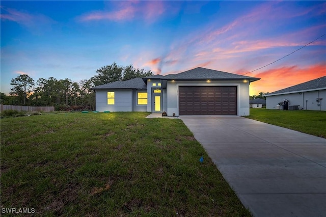 2605 Darlene Pl, Lehigh Acres, FL 33971 - view of front of home featuring driveway, a garage, stucco siding, and cooling unit