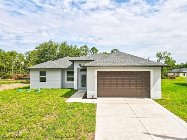 2605 Darlene Pl, Lehigh Acres, FL 33971 - prairie-style house featuring stucco siding, roof with shingles, an attached garage, a front lawn, and driveway