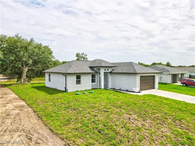 2605 Darlene Pl, Lehigh Acres, FL 33971 - view of front facade with concrete driveway, a garage, a front lawn, and stucco siding