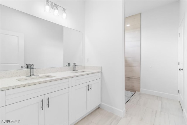 2605 Darlene Pl, Lehigh Acres, FL 33971 - bathroom featuring baseboards and double vanity