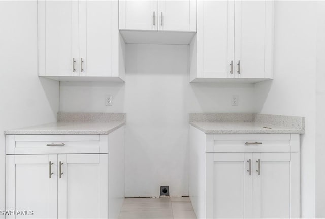 2605 Darlene Pl, Lehigh Acres, FL 33971 - kitchen with white cabinetry and light stone countertops