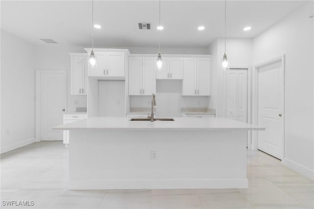 2605 Darlene Pl, Lehigh Acres, FL 33971 - kitchen with a sink, a spacious island, white cabinetry, baseboards, and recessed lighting