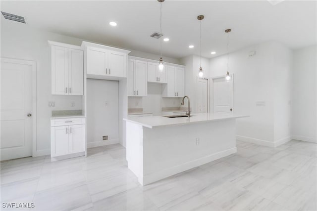 2605 Darlene Pl, Lehigh Acres, FL 33971 - kitchen featuring a sink, white cabinetry, an island with sink, recessed lighting, and light countertops