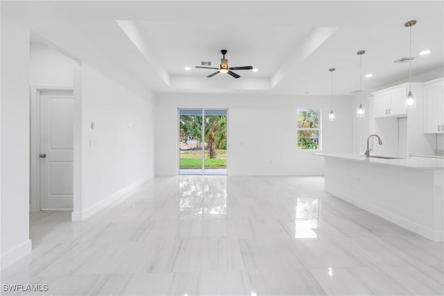 2605 Darlene Pl, Lehigh Acres, FL 33971 - unfurnished living room with a sink, plenty of natural light, a raised ceiling, a ceiling fan, and recessed lighting