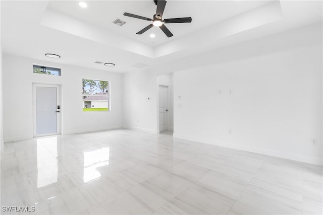 2605 Darlene Pl, Lehigh Acres, FL 33971 - spare room featuring a tray ceiling, ceiling fan, baseboards, and recessed lighting