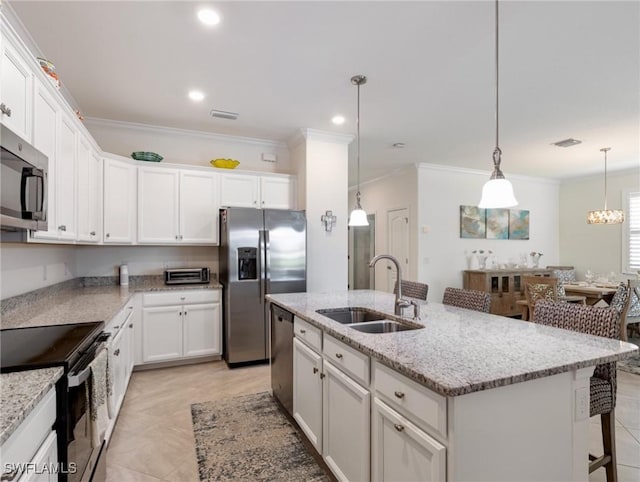 11992 Arbor Trace Dr, Fort Myers, FL 33913 - kitchen featuring stainless steel appliances, white cabinets, ornamental molding, a center island with sink, and light stone countertops