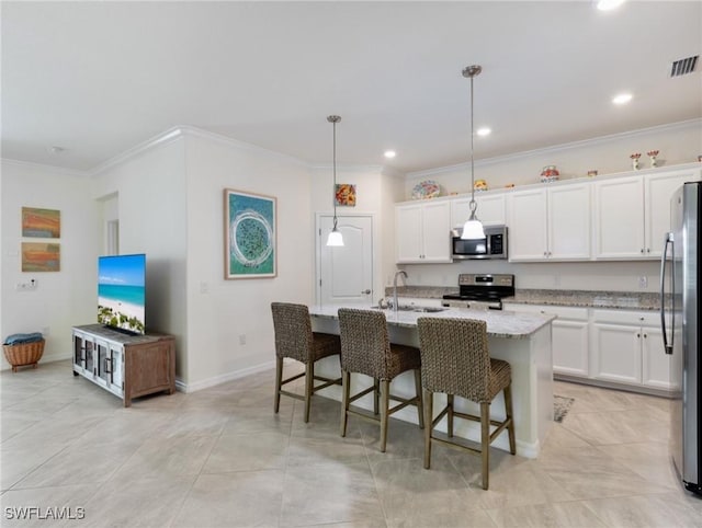 11992 Arbor Trace Dr, Fort Myers, FL 33913 - kitchen with appliances with stainless steel finishes, ornamental molding, white cabinetry, light stone countertops, and an island with sink