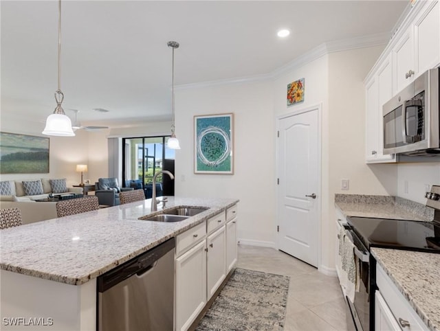 11992 Arbor Trace Dr, Fort Myers, FL 33913 - kitchen featuring appliances with stainless steel finishes, crown molding, white cabinets, open floor plan, and a kitchen island with sink