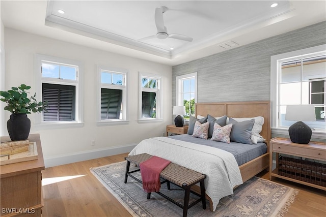 845 11th Ave S, Naples, FL 34102 - bedroom featuring a tray ceiling, baseboards, wallpapered walls, recessed lighting, and wood finished floors