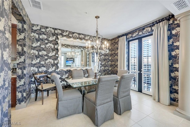 23159 Amgci Way Unit 302, Estero, FL 33928 - dining area with a chandelier, tile patterned flooring, wallpapered walls, and baseboards
