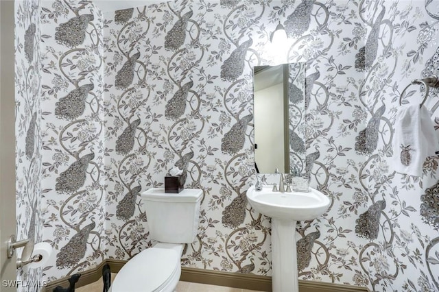 23159 Amgci Way Unit 302, Estero, FL 33928 - bathroom with wallpapered walls, toilet, and baseboards