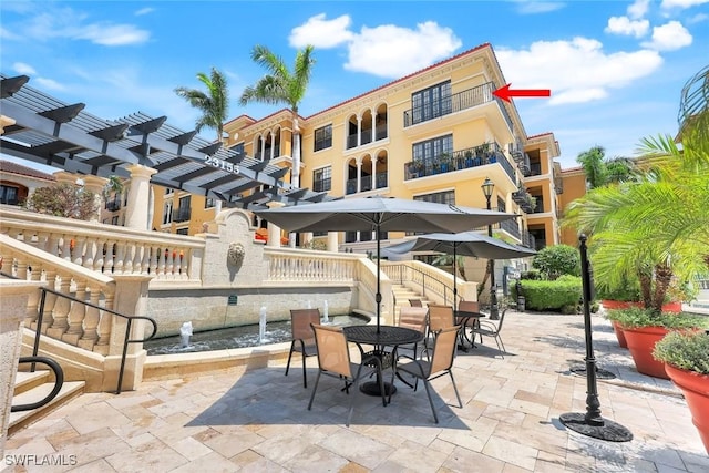 23159 Amgci Way Unit 302, Estero, FL 33928 - view of patio featuring outdoor dining space