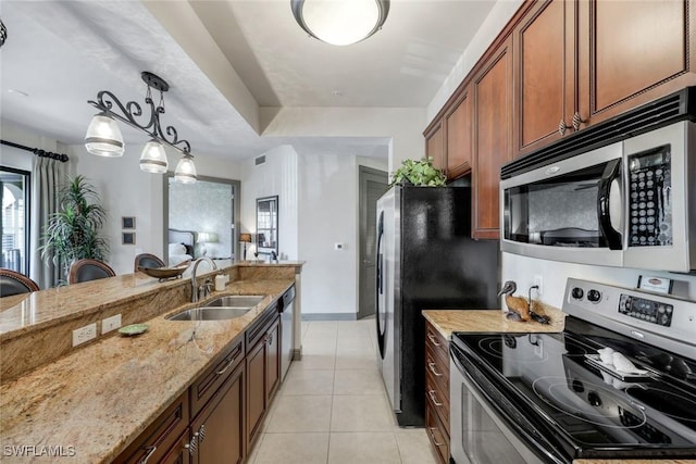 23159 Amgci Way Unit 302, Estero, FL 33928 - kitchen featuring stainless steel appliances, a sink, light stone countertops, light tile patterned floors, and decorative light fixtures