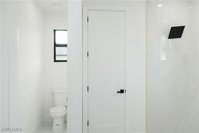 718 Calvin Ave, Lehigh Acres, FL 33972 - bathroom featuring baseboards, toilet, and a shower