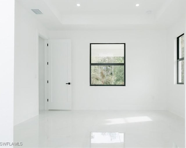 718 Calvin Ave, Lehigh Acres, FL 33972 - tiled empty room featuring a raised ceiling and recessed lighting