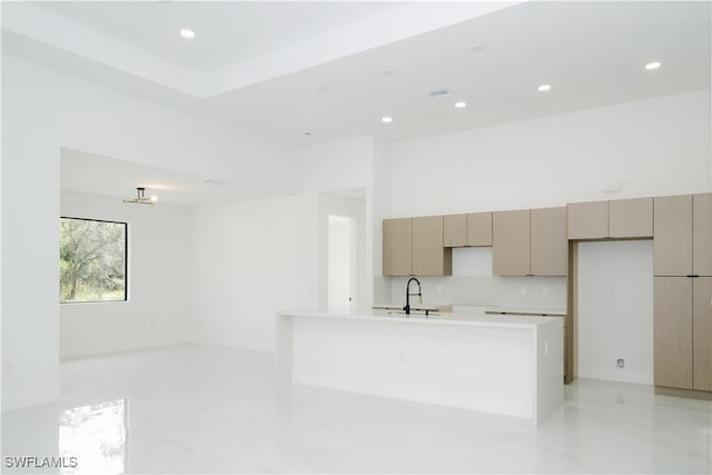 718 Calvin Ave, Lehigh Acres, FL 33972 - kitchen featuring light countertops, recessed lighting, a sink, a center island with sink, and modern cabinets