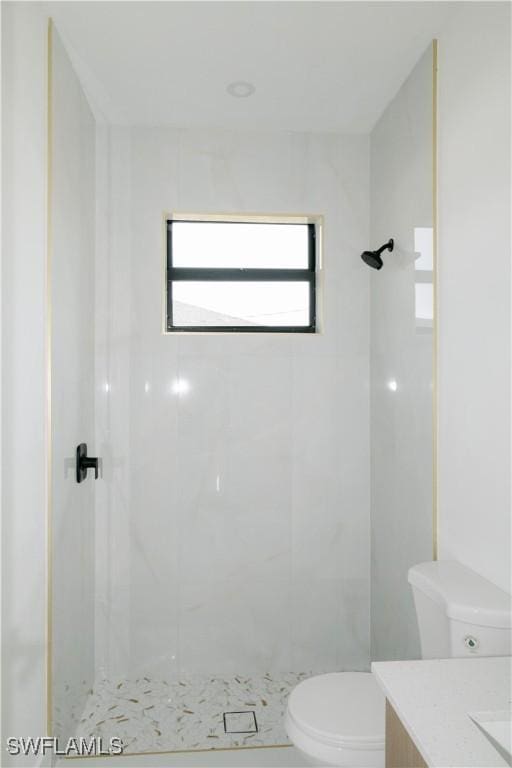 718 Calvin Ave, Lehigh Acres, FL 33972 - bathroom with toilet, a tile shower, and vanity