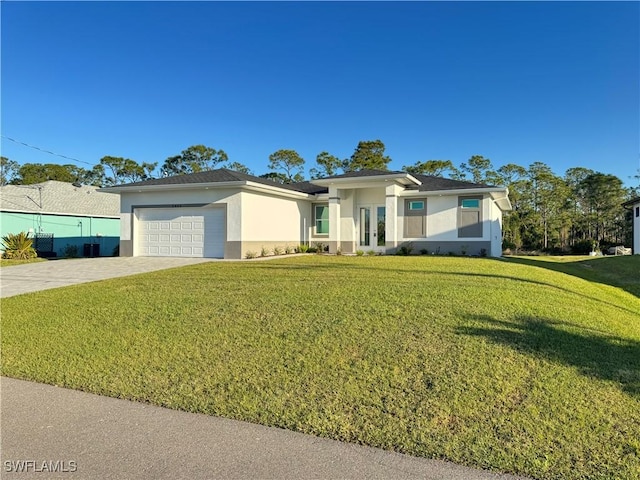 2933 Van Buren Pkwy, Cape Coral, FL 33993 - prairie-style house featuring stucco siding, french doors, an attached garage, decorative driveway, and a front yard