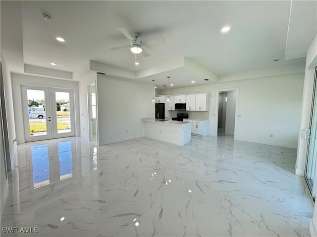 2933 Van Buren Pkwy, Cape Coral, FL 33993 - unfurnished living room with a ceiling fan, recessed lighting, french doors, light marble finish floors, and a tray ceiling