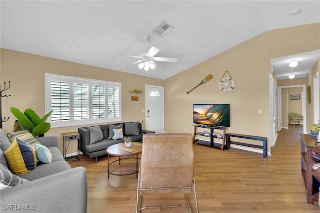 291 Mango St, Fort Myers Beach, FL 33931 - living area with light wood finished floors, vaulted ceiling, and a ceiling fan