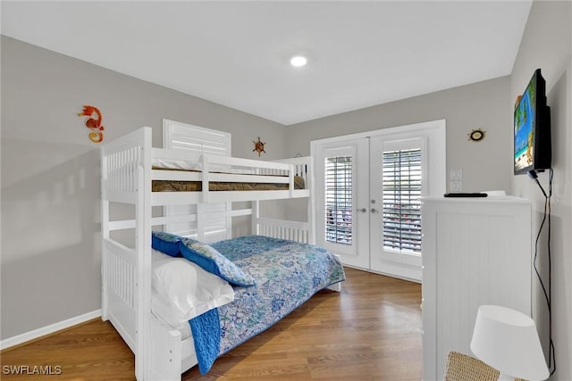 291 Mango St, Fort Myers Beach, FL 33931 - bedroom with french doors, access to exterior, wood finished floors, and baseboards