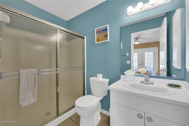291 Mango St, Fort Myers Beach, FL 33931 - bathroom featuring vanity, a stall shower, tile patterned floors, toilet, and french doors