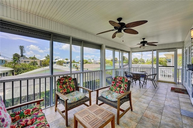 291 Mango St, Fort Myers Beach, FL 33931 - sunroom / solarium with ceiling fan, outdoor dining space, and a residential view