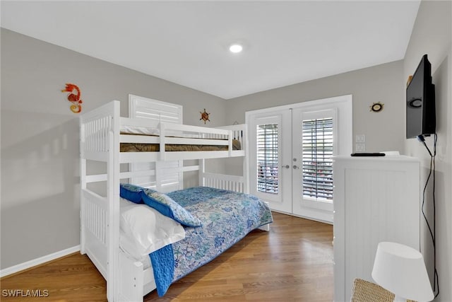 291 Mango St, Fort Myers Beach, FL 33931 - bedroom with french doors, access to outside, wood finished floors, and baseboards