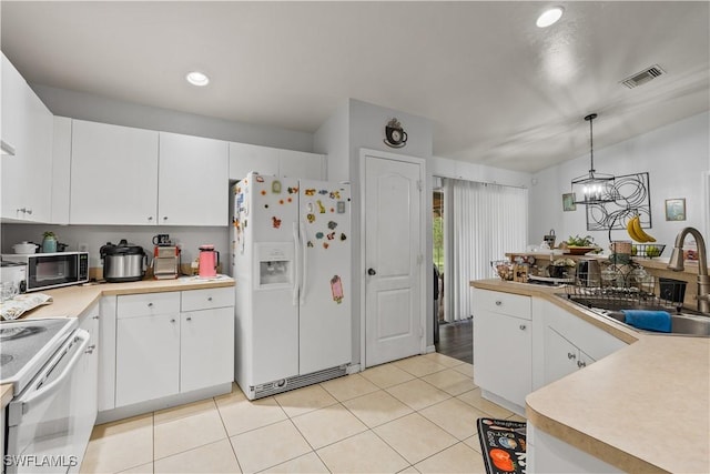 2909 48th St SW, Lehigh Acres, FL 33976 - kitchen with white appliances, a sink, light tile patterned floors, pendant lighting, and light countertops