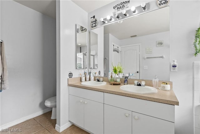 2909 48th St SW, Lehigh Acres, FL 33976 - bathroom with double vanity, toilet, tile patterned flooring, and baseboards