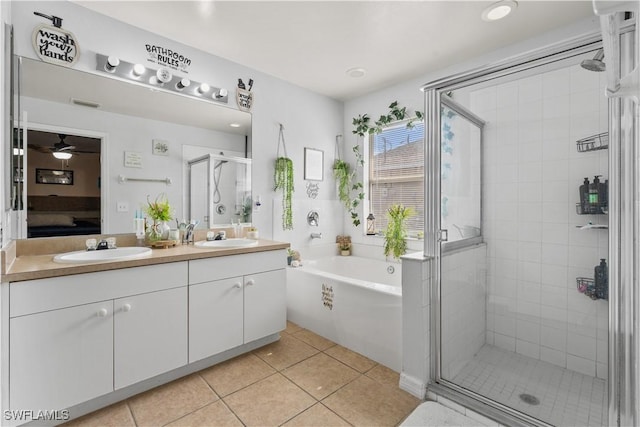 2909 48th St SW, Lehigh Acres, FL 33976 - ensuite bathroom with a stall shower, a bath, tile patterned floors, double vanity, and ceiling fan