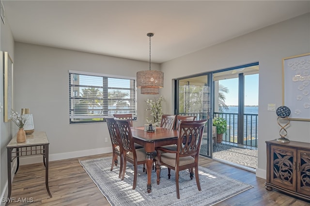1925 Clifford St Unit 101, Fort Myers, FL 33901 - dining area featuring healthy amount of natural light, wood finished floors, a chandelier, and baseboards