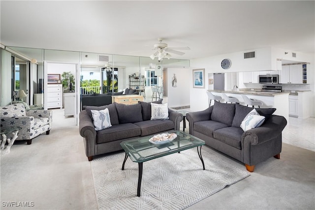 5550 Heron Point Dr W Unit 305, Naples, FL 34108 - living room with light colored carpet and ceiling fan