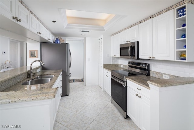 5550 Heron Point Dr W Unit 305, Naples, FL 34108 - kitchen with appliances with stainless steel finishes, a sink, a raised ceiling, white cabinets, and light tile patterned floors