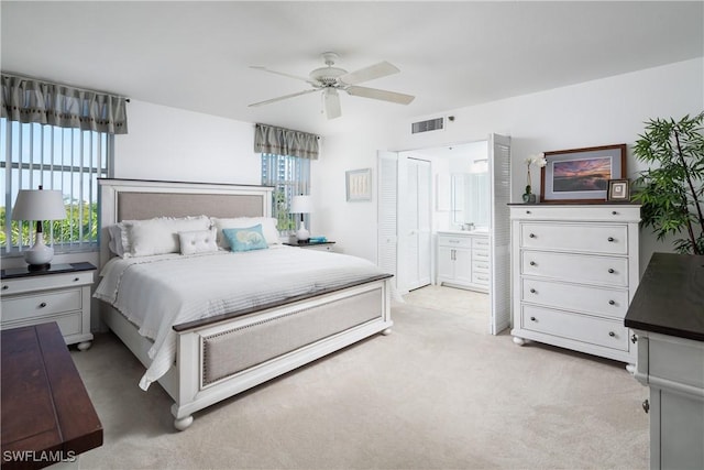 5550 Heron Point Dr W Unit 305, Naples, FL 34108 - bedroom with multiple windows, light colored carpet, ensuite bath, and ceiling fan