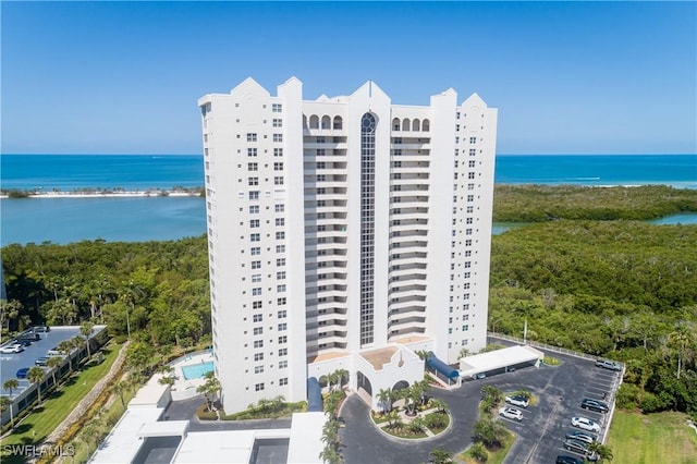 5550 Heron Point Dr W Unit 305, Naples, FL 34108 - view of apartment building / complex featuring a water view and uncovered parking