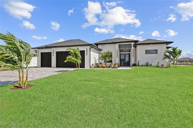 220 NE 6th St, Cape Coral, FL 33909 - prairie-style house with an attached garage, a front lawn, driveway, and stucco siding