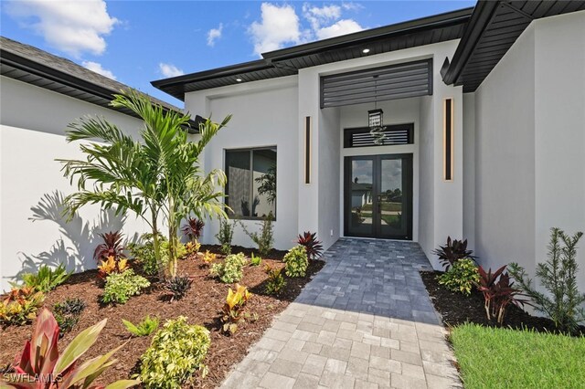 220 NE 6th St, Cape Coral, FL 33909 - entrance to property with french doors and stucco siding