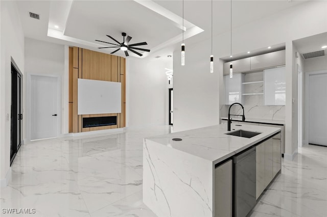 220 NE 6th St, Cape Coral, FL 33909 - kitchen with modern cabinets, a sink, a raised ceiling, light marble finish floors, and recessed lighting