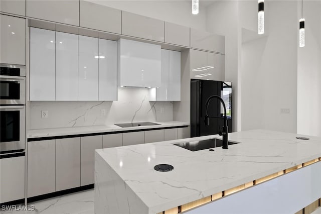 220 NE 6th St, Cape Coral, FL 33909 - kitchen featuring modern cabinets, black appliances, a sink, white cabinets, and light marble finish flooring