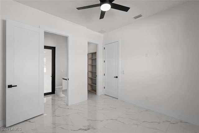 220 NE 6th St, Cape Coral, FL 33909 - unfurnished bedroom with light marble finish floors, baseboards, connected bathroom, and ceiling fan