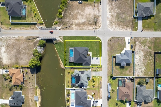 220 NE 6th St, Cape Coral, FL 33909 - aerial perspective of suburban area featuring property parcel outlined and a large body of water