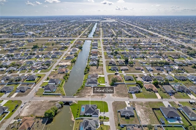 220 NE 6th St, Cape Coral, FL 33909 - aerial view of property and surrounding area featuring nearby suburban area and a nearby body of water