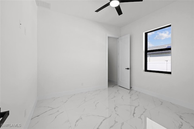 220 NE 6th St, Cape Coral, FL 33909 - empty room with baseboards, ceiling fan, and marble finish flooring