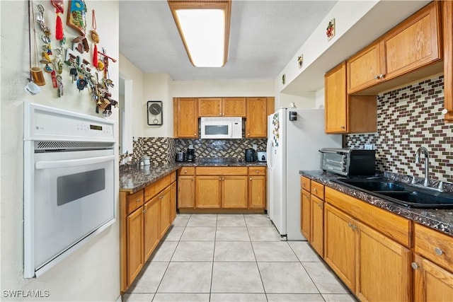 804 Alcala Ave, Lehigh Acres, FL 33936 - kitchen featuring white appliances, a sink, tasteful backsplash, and brown cabinetry