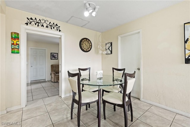 804 Alcala Ave, Lehigh Acres, FL 33936 - dining space featuring baseboards and light tile patterned flooring