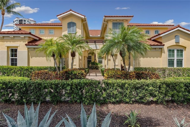 1263 Rialto Way Unit 102, Naples, FL 34114 - mediterranean / spanish house featuring stucco siding and a tiled roof